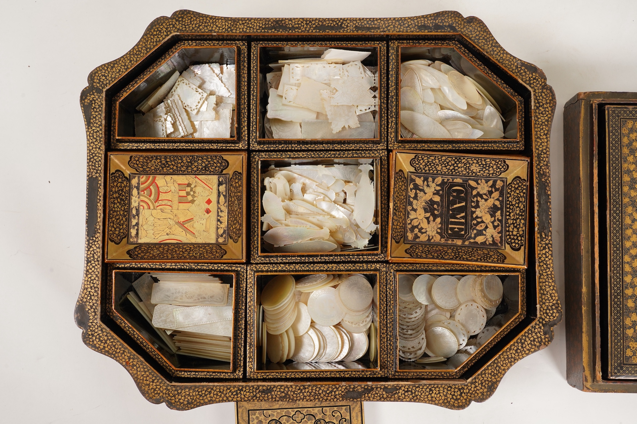 Two Chinese gilt decorated black lacquer games boxes, containing numerous mother-of-pearl counters, 19th century